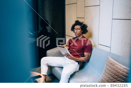 Young male blogger typing text publication via application on digital tablet Young male blogger typing text publication via application on digital tablet 89432285