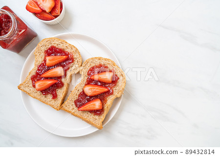 whole wheat bread with strawberry jam and fresh strawberry 89432814