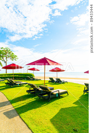 umbrella and beach chair with sea beach background and blue sky umbrella and beach chair with sea beach background and blue sky 89433444