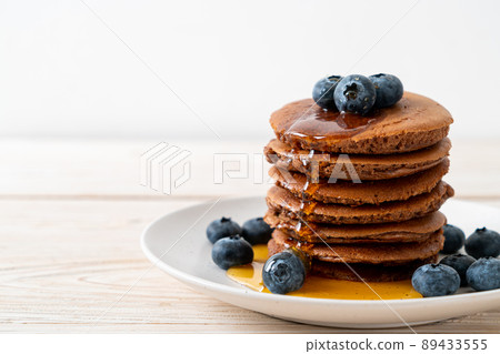 chocolate pancake stack with blueberry and honey 89433555