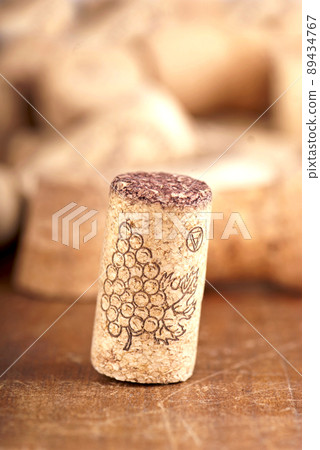 bottle corks on the wooden background. Dated wine bottle corks on the wooden background. Close up 89434767