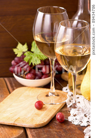 white wine and fruits. Wine and grapes in vintage setting on wooden table white wine and fruits. Wine and grapes in vintage setting on wooden table 89434786