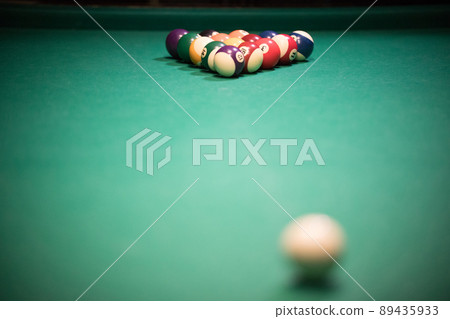 Entertainment concept. Billiard table with bright colored balls Entertainment concept. Billiard table with bright colored balls 89435933