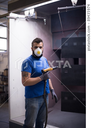 The painter paints the iron element. Industrial painting parts. Metal designs The painter paints the iron element. Industrial painting parts. Metal designs 89435974