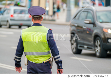Traffic officer standing near road 89436763