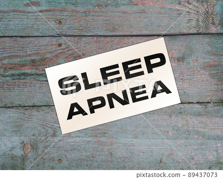 Text Sleep APNEA on card on wooden table. Healthcare concept 89437073