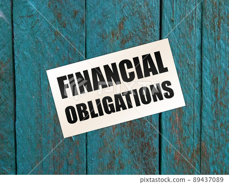 Financial Obligation words on card on wooden table. Business debts concept Financial Obligation words on card on wooden table. Business debts concept 89437089