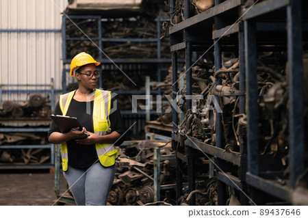 black african women worker working inspect check stock inventory of machine part warehouse 89437646