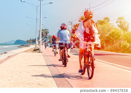 people riding a bicycle along the beach longest road shore in Pranburi Thailand 89437838