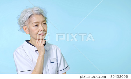 Senior woman in a white coat thinking Senior woman in a white coat thinking 89438096
