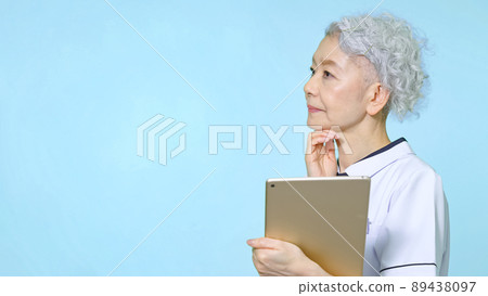 Senior woman in a white coat thinking Senior woman in a white coat thinking 89438097