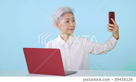 Senior women using smartphones and computers 89438126