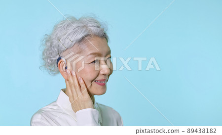 Senior woman wearing a hearing aid Senior woman wearing a hearing aid 89438182
