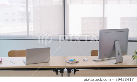 Modern workplace with computer pc, laptop, potted plant and office supplies on wooden table. Modern workplace with computer pc, laptop, potted plant and office supplies on wooden table. 89438417