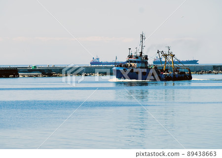 Fishing ship goes via Baltic sea channel to base Fishing ship goes via Baltic sea channel to base 89438663