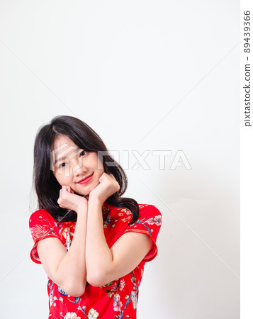 Written by a traditional flag, a female cheongsam, in front of a white background. 89439366