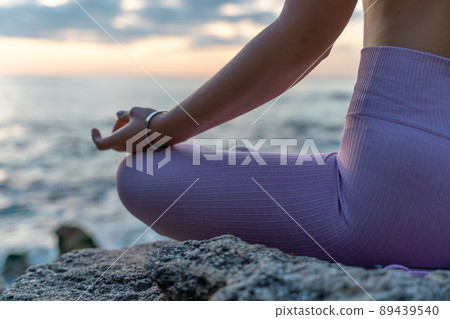 Young woman practicing yoga outdoors. Harmony and meditation concept. Healthy lifestyle 89439540