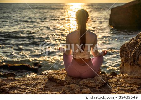 Young woman practicing yoga outdoors. Harmony and meditation concept. Healthy lifestyle Young woman practicing yoga outdoors. Harmony and meditation concept. Healthy lifestyle 89439549