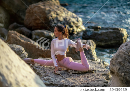 Girl gymnast trains on the beach by the sea. Photo series Girl gymnast trains on the beach by the sea. Photo series 89439689