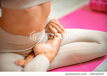 Close up hand and half body of healthy woman sit in lotus Yoga position.Young healthy woman sitting posture exercise in home.Concept of meditating,lifestyle and relaxation. Close up hand and half body of healthy woman sit in lotus Yoga position.Young healthy woman sitting posture exercise in home.Concept of meditating,lifestyle and relaxation. 89440997