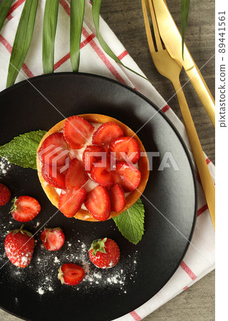 Concept of tasty food with strawberry tart on gray textured table 89441561