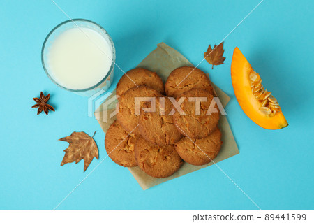 Milk and pumpkin cookies on blue background Milk and pumpkin cookies on blue background 89441599