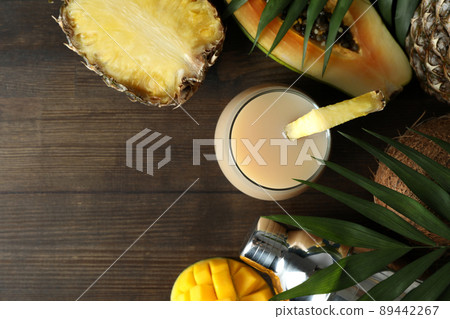 Pina colada cocktail and ingredients on wooden table Pina colada cocktail and ingredients on wooden table 89442267