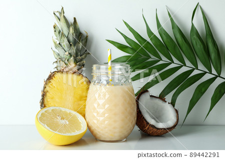 Pina colada cocktail and ingredients on white table 89442291