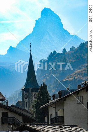The male figure of the Matterhorn and the clock tower of Zermatt village 89442402