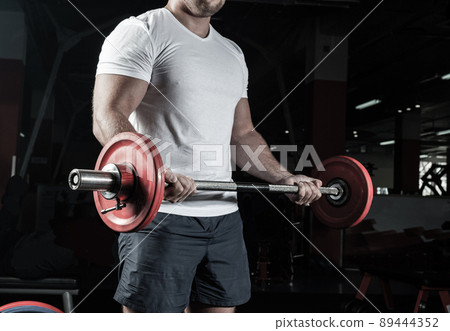 Male athlete lifts the barbell Male athlete lifts the barbell 89444352