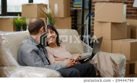 Young couple searching home decor inspiration on laptop doing online shopping to buy furniture and move in rented apartment flat. Decorating household space, using online website. Young couple searching home decor inspiration on laptop doing online shopping to buy furniture and move in rented apartment flat. Decorating household space, using online website. 89444794