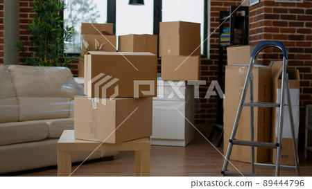 Empty new apartment space with furniture packages in boxes, moving in household property. No people in real estate house to move with things in storage cardboard cargo containers. Empty new apartment space with furniture packages in boxes, moving in household property. No people in real estate house to move with things in storage cardboard cargo containers. 89444796