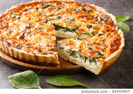 Quiche Florentine is a fresh spinach quiche baked in a homemade pie crust to serve for brunch or breakfast for dinner close-up. Hotizontal Quiche Florentine is a fresh spinach quiche baked in a homemade pie crust to serve for brunch or breakfast for dinner close-up. Hotizontal 89444907