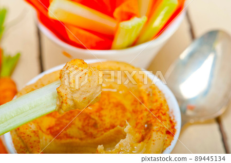 fresh hummus dip with raw carrot and celery fresh hummus dip with raw carrot and celery 89445134