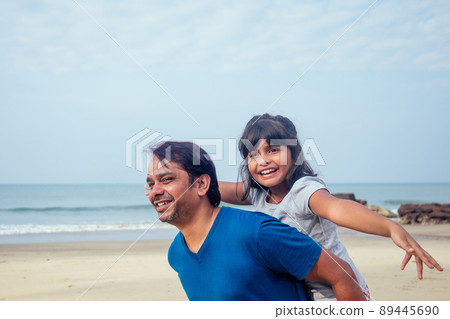 happy daughter and father having fun together in Goa .travel medical insurance concept happy daughter and father having fun together in Goa .travel medical insurance concept 89445690