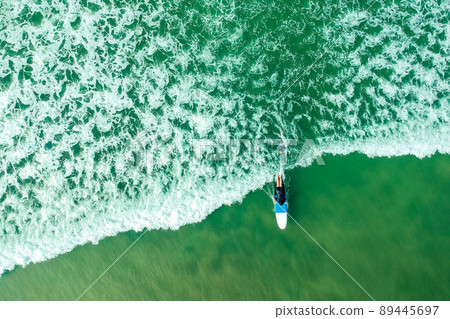 surf instructor and woman learning extreme water sport in Goa surf instructor and woman learning extreme water sport in Goa 89445697