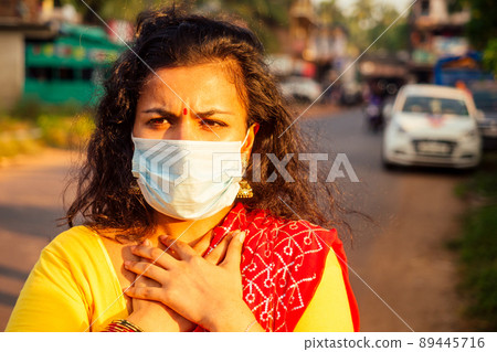 portrait of a young indian woman wearing mask. the concept of tourism, health and safety in the Asian and India countries portrait of a young indian woman wearing mask. the concept of tourism, health and safety in the Asian and India countries 89445716