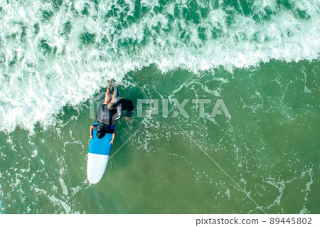 surf instructor and woman learning extreme water sport in Goa 89445802