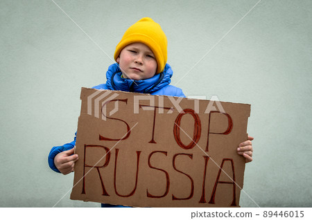 Board Stop russia. No war in Ukraine. Stop war. Little ukrainian patriot boy support Ukraine. No war with Ukraine. Ukrainian geopolitics globe crisis. School kid boy in flag colores. 89446015
