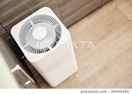 White air purifier in the kitchen of the apartment. Close-up, selective focus White air purifier in the kitchen of the apartment. Close-up, selective focus 89446480
