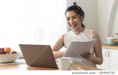 young Asian businesswoman using computer laptop talking for video call conference meeting. work from home concept. young Asian businesswoman using computer laptop talking for video call conference meeting. work from home concept. 89446795