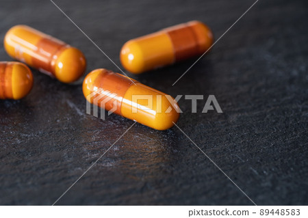 橙色膠囊藥。感冒和維生素。 89448583