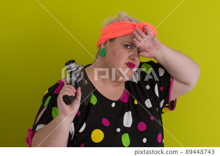 plus size smiling woman with funny emotional face expression with vintage camera in dress isolated on green background, traveler on vacation, summer fashion style, excited tourist. plus size smiling woman with funny emotional face expression with vintage camera in dress isolated on green background, traveler on vacation, summer fashion style, excited tourist. 89448743