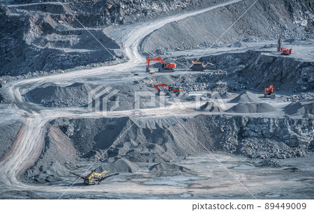 Excavators and drill rigs work in stone quarry 89449009
