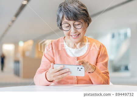 Senior woman wearing glasses who operates a smartphone Photo cooperation "LINK FOREST" 89449732