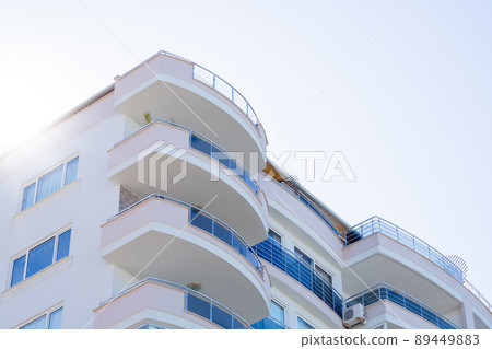 Part of a modern apartment building with large and spacious balconies. 89449883