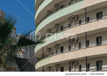 Part of the hotel with large, shared, long balconies. 89449884