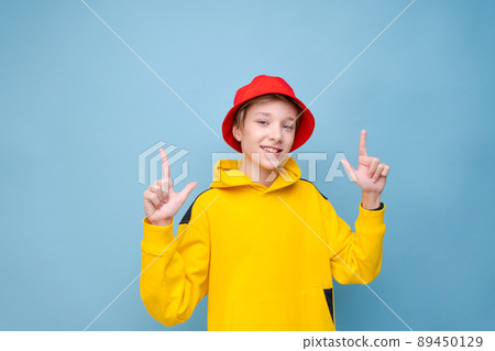 Wow, this is incredible. Shocked caucasian teenager in red hat and yellow Wow, this is incredible. Shocked caucasian teenager in red hat and yellow 89450129