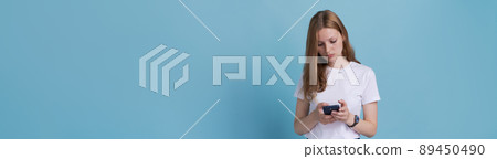 Important text message. European girl is worried about text message on her 89450490
