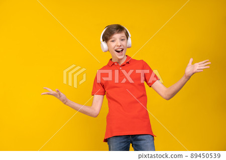 Relaxed young man in casual red shirt posing isolated on yellow background 89450539